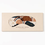 Migraine Mask by Slow North. Strap free cotton weighted eye pillow to be used hot or cold to sooth headaches and tired eyes. Tan, maroon, and navy rainstorm design in tan packaging. White background.