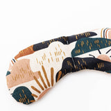 Migraine Mask by Slow North. Strap free cotton weighted eye pillow to be used hot or cold to sooth headaches and tired eyes. Zoomed in on tan, maroon, and navy rainstorm design. White background.