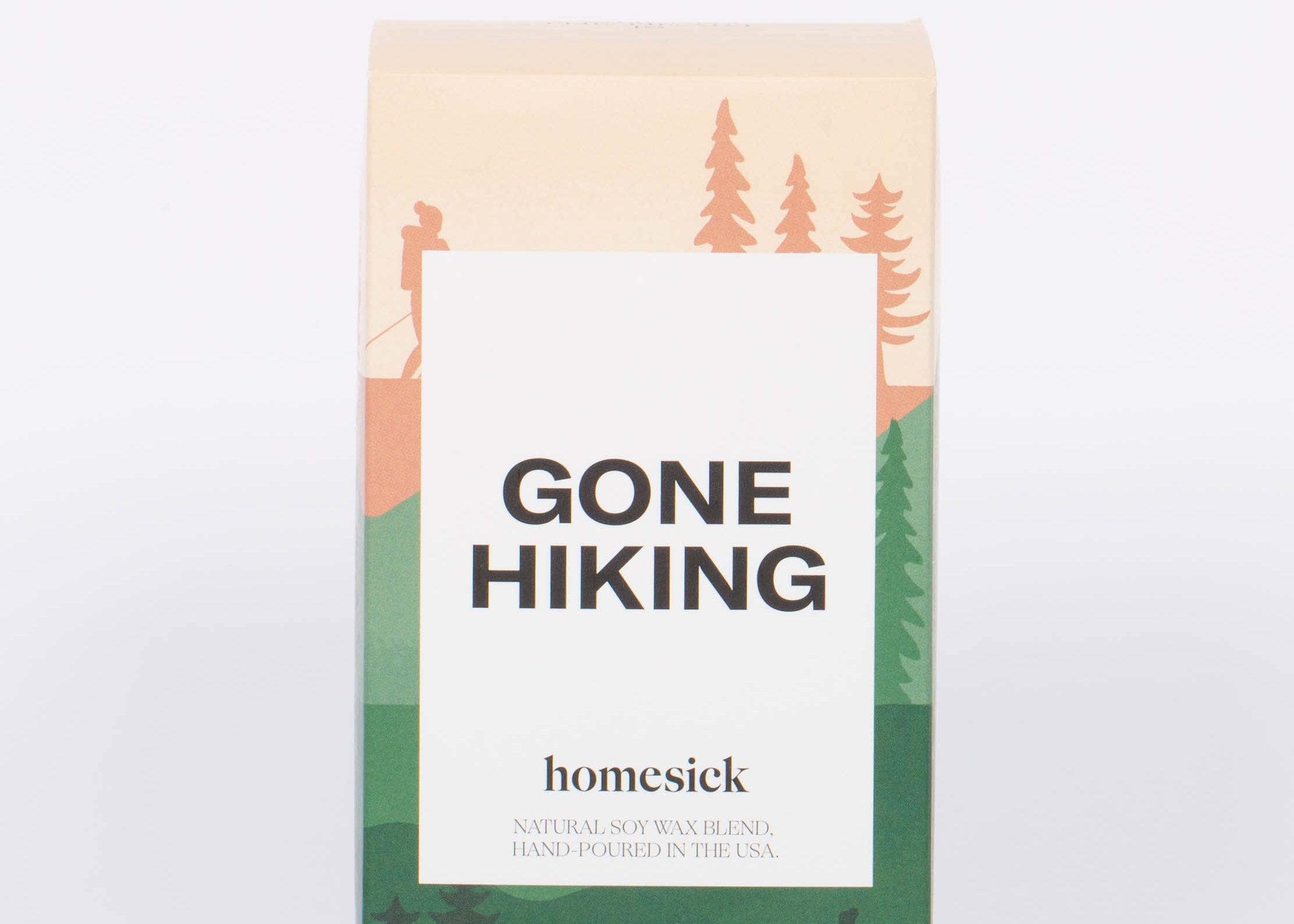 Gone Hiking candle box with pink and green hiking and forest illustration and white label with bold "GONE HIKING" label. 