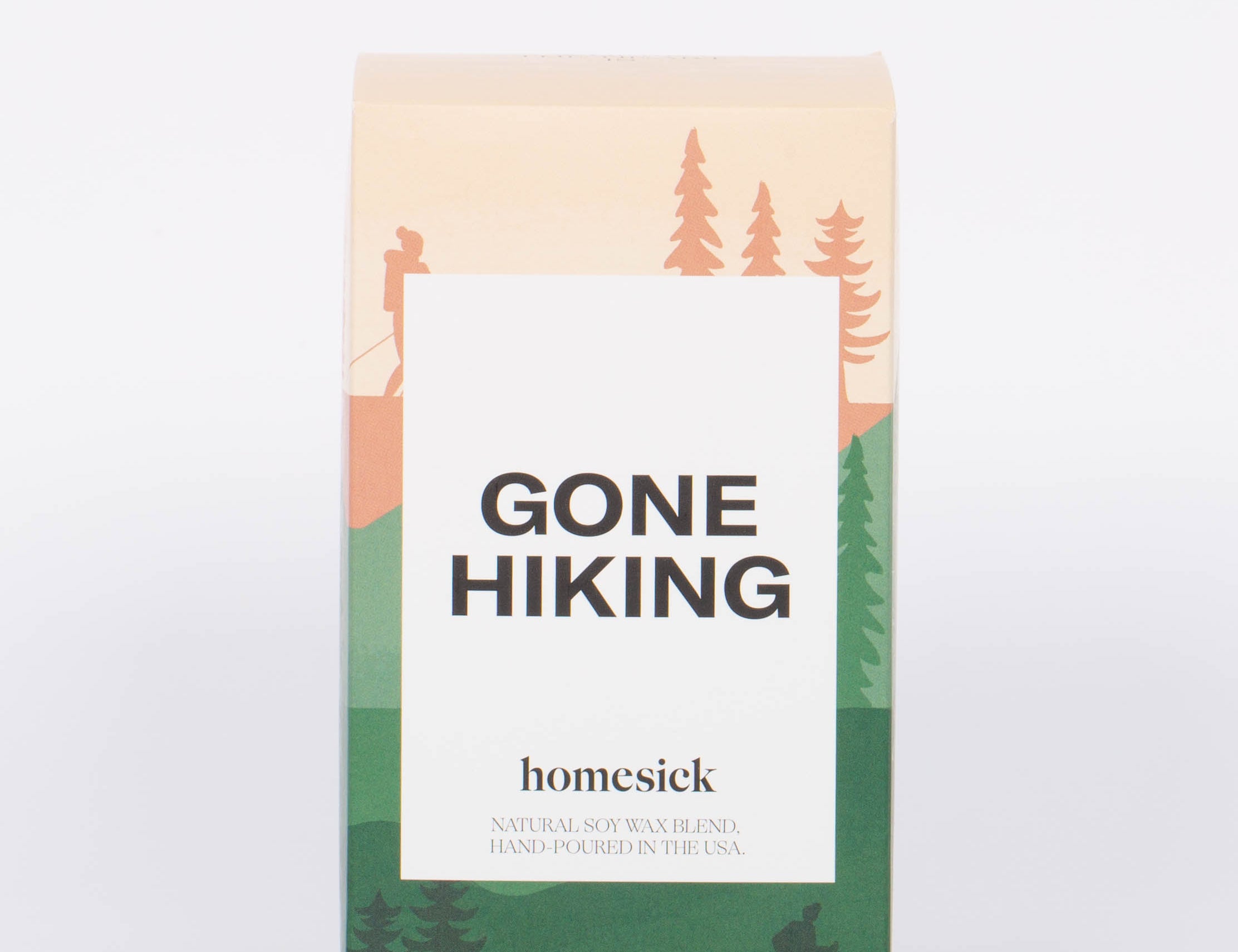 Gone Hiking candle box with pink and green hiking and forest illustration and white label with bold "GONE HIKING" label. 