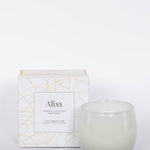 16oz Heure du Thé Ballon candle by Alixx in white with white and gold pattern box. Lily of the valley, water cedar, and musk fragrance. White background.
