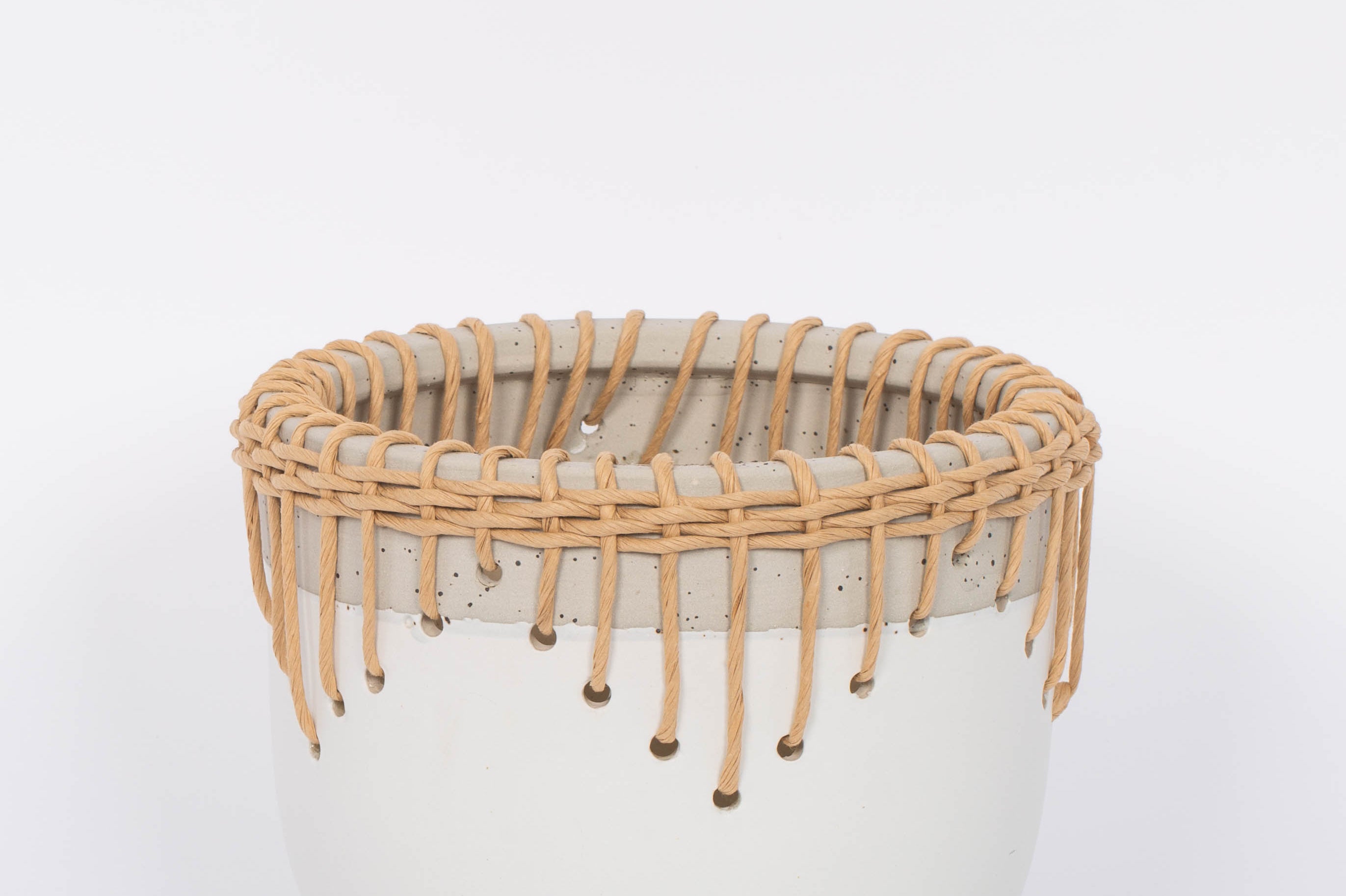 White Hideaway Pot with two tone neutral base and woven rattan detailing around top rim.  White background.