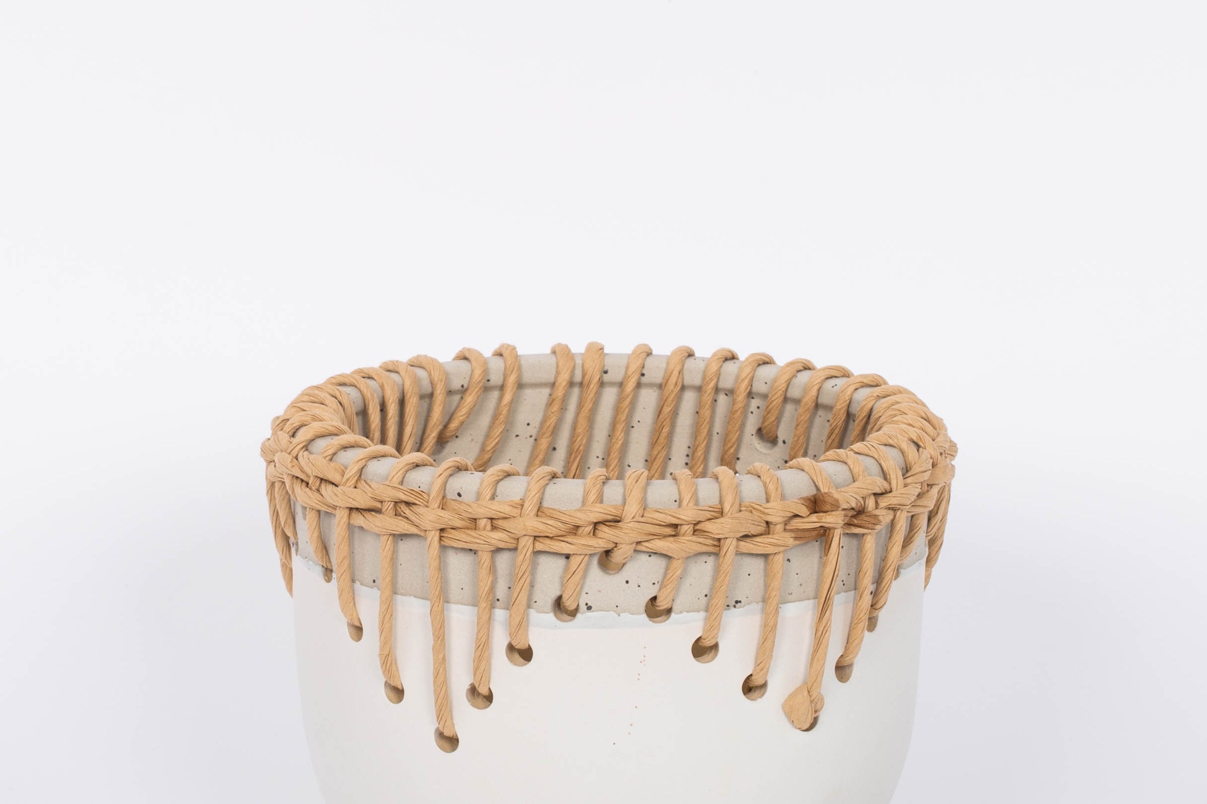 White Hideaway Pot with two tone neutral base and woven rattan detailing around top rim.  White background.