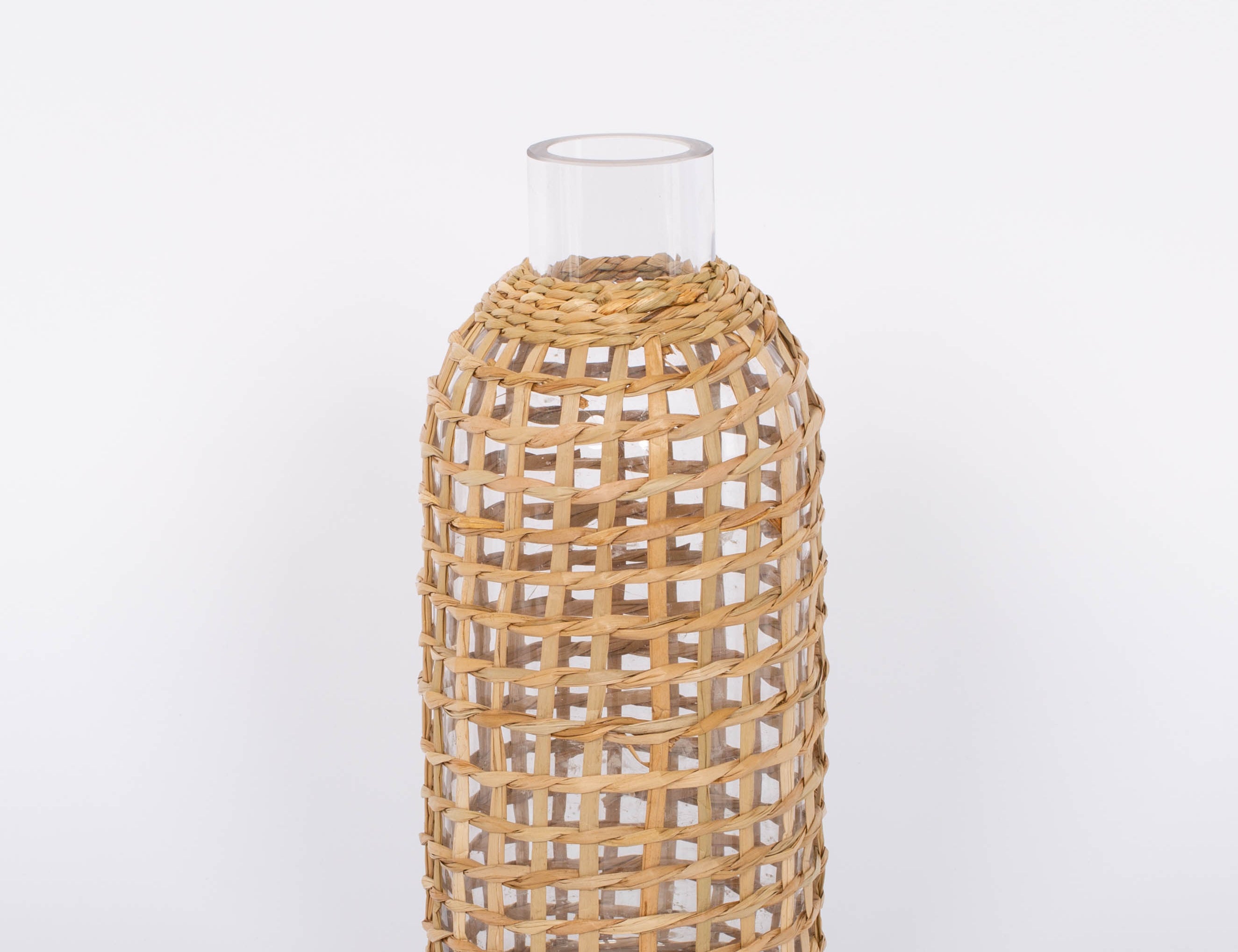 Jaxon Caraffe rattan covered glass vase in neutral light basket tone.  White background.
