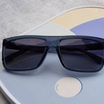 Blue sunglasses on a colorful circular object