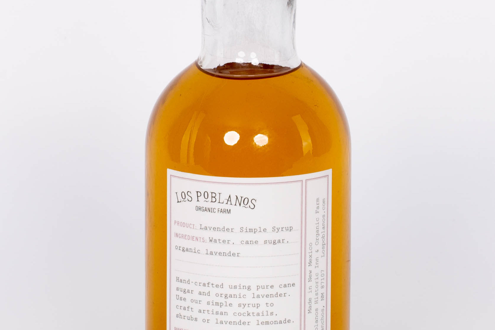 Golden Lavender Simple Syrup by Los Poblanos in glass bottle with gold cap. 