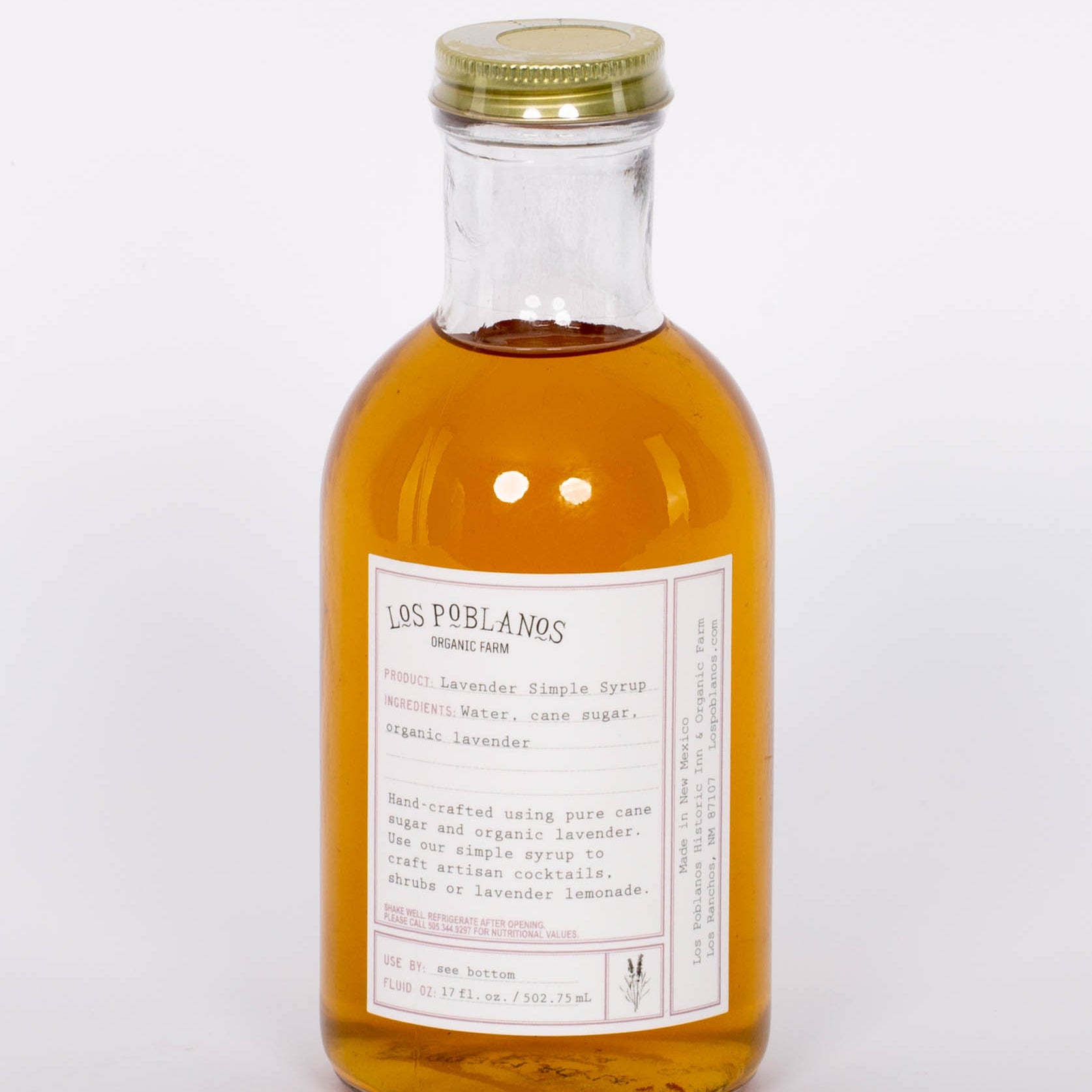 Golden Lavender Simple Syrup by Los Poblanos in glass bottle with gold cap. 