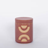 Paddywax blush colored Mandarin Mango Candle and white background.