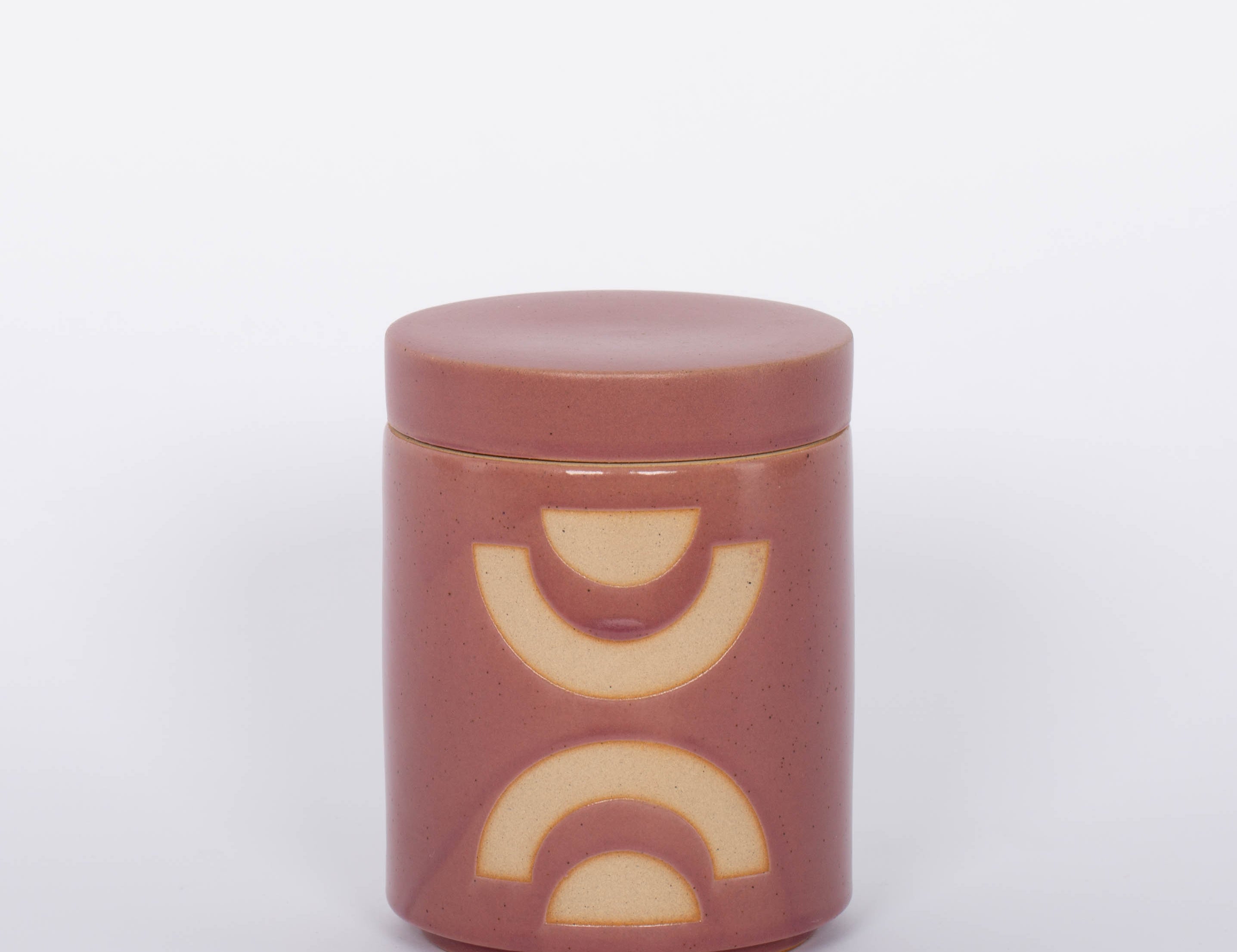 Paddywax blush colored Mandarin Mango Candle and white background.