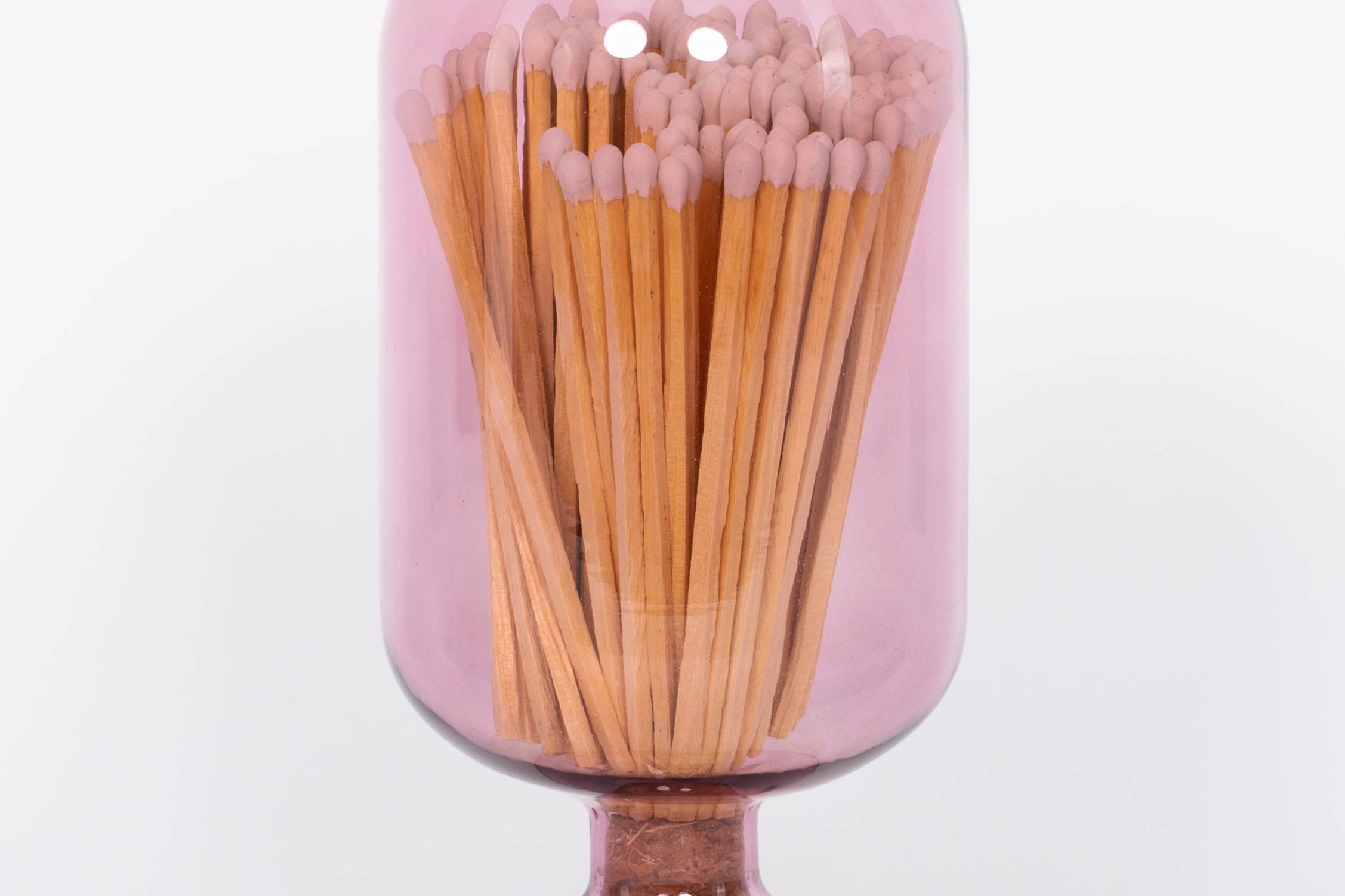 Mulberry colored Match Cloche by Skeem in jewel-toned vintage glass domes fitted with cork, holding 120 matches. White background.