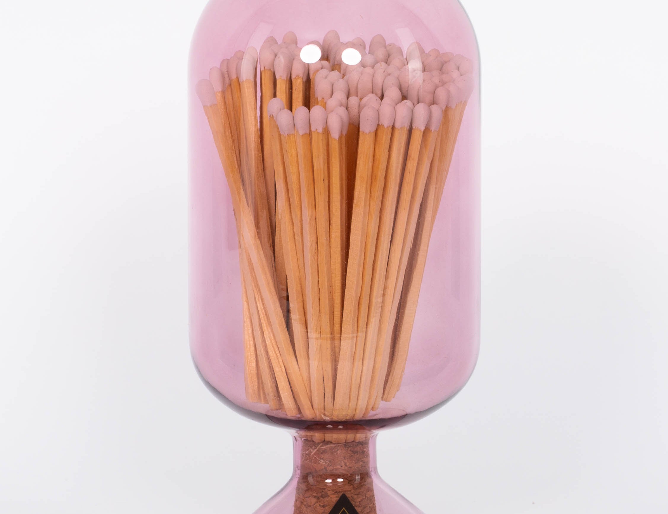 Mulberry colored Match Cloche by Skeem in jewel-toned vintage glass domes fitted with cork, holding 120 matches. White background.