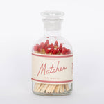Red Safety Matches by Paddywax with match striker on back of clear glass bottle and red match tips.
