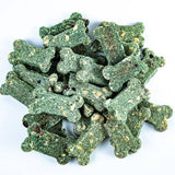 Green dog treats shaped like bones on a white background