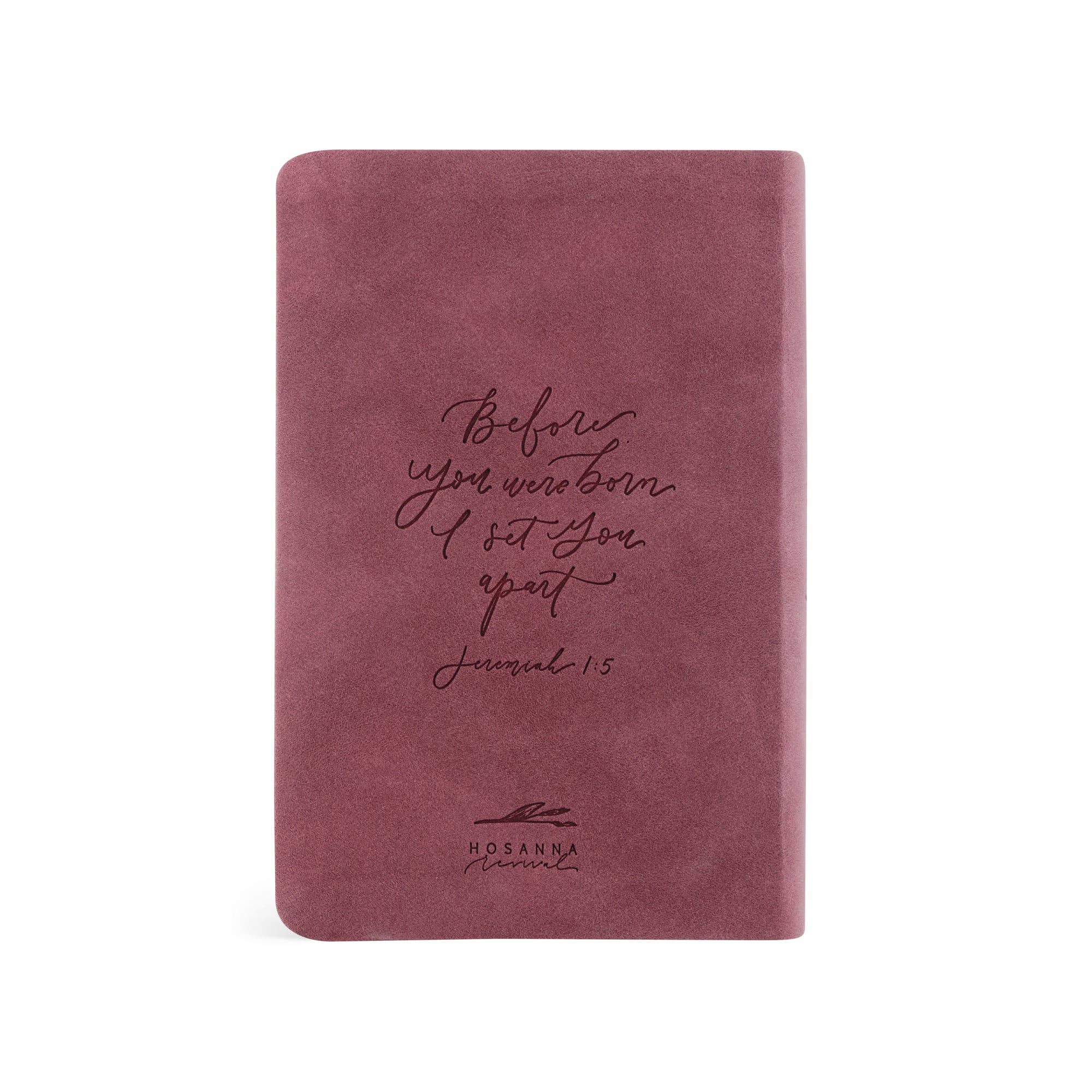 Mauve notebook with text and branding on a white background