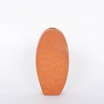 Tall oval Poppy Budvase in terracotta geometric silhouette with imprint of live plant. White background.