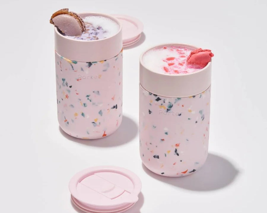 Blush Terrazzo Ceramic Porter Mug. Silicone sleeve is grippable, soft on the hands, and prevents scratches on surface. Splash-resistant lid. Microwave & dishwasher safe.