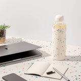 Terrazzo Cream Porter Water Bottle Your go-to reusable glass bottle helps you ditch the plastic and upgrade your hydration game.  Reduce. Reuse. Refill.