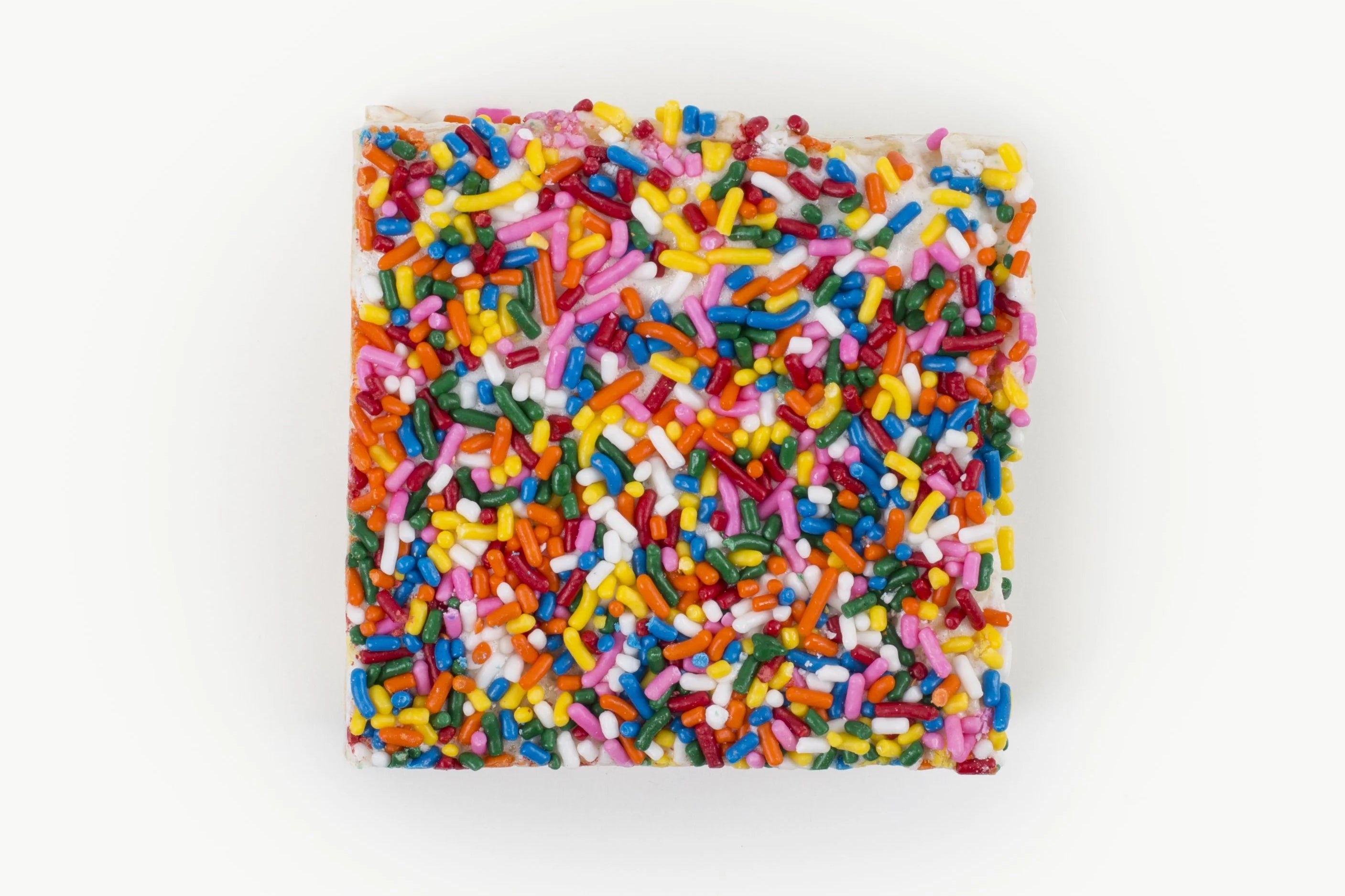 Square Rainbow Sprinkles Crispy Cake by Lolli & Pops on white background. 