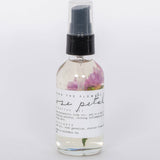 Rose Petal Body Oil by Among the Flowers in clear spray bottle white label. 