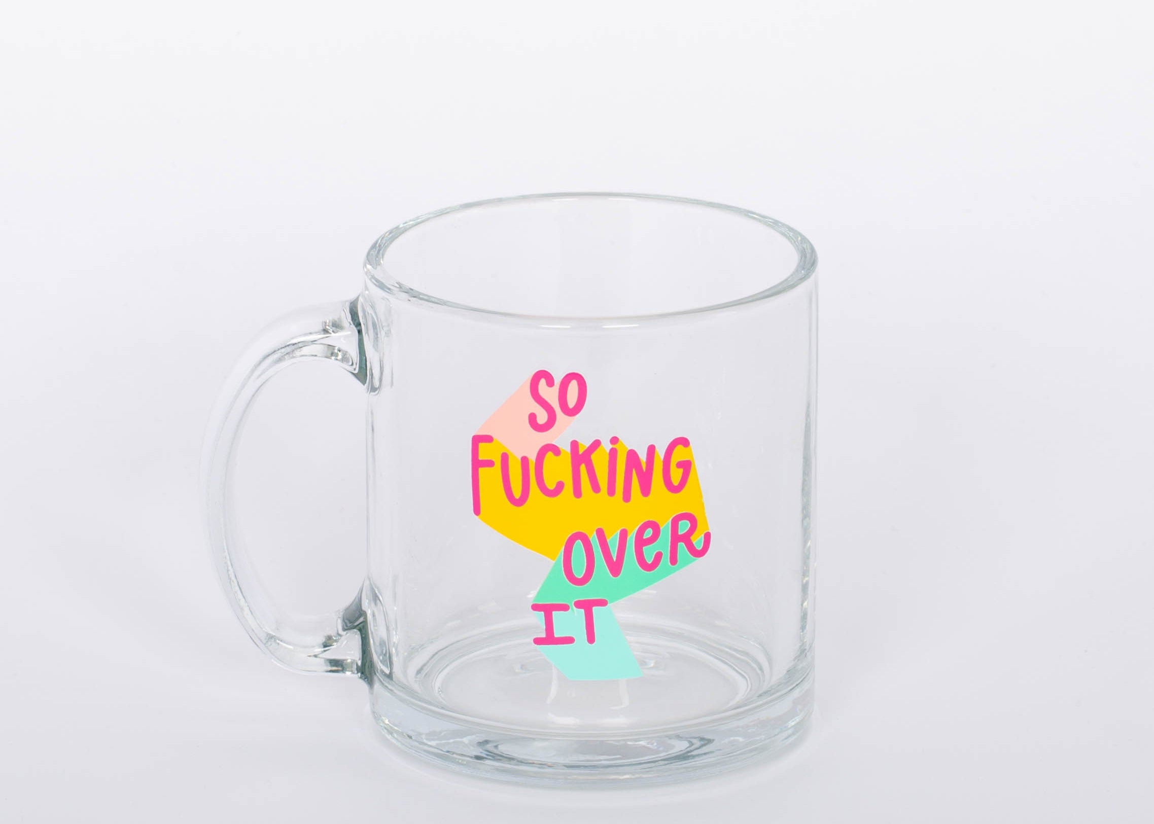 "So Fucking Over It" glass mug. Coffee, tea, hot chocolate, whatever beverage you love, our mug will keep them nice and warm for you. Plus, you'll look super cute drinking out of it.