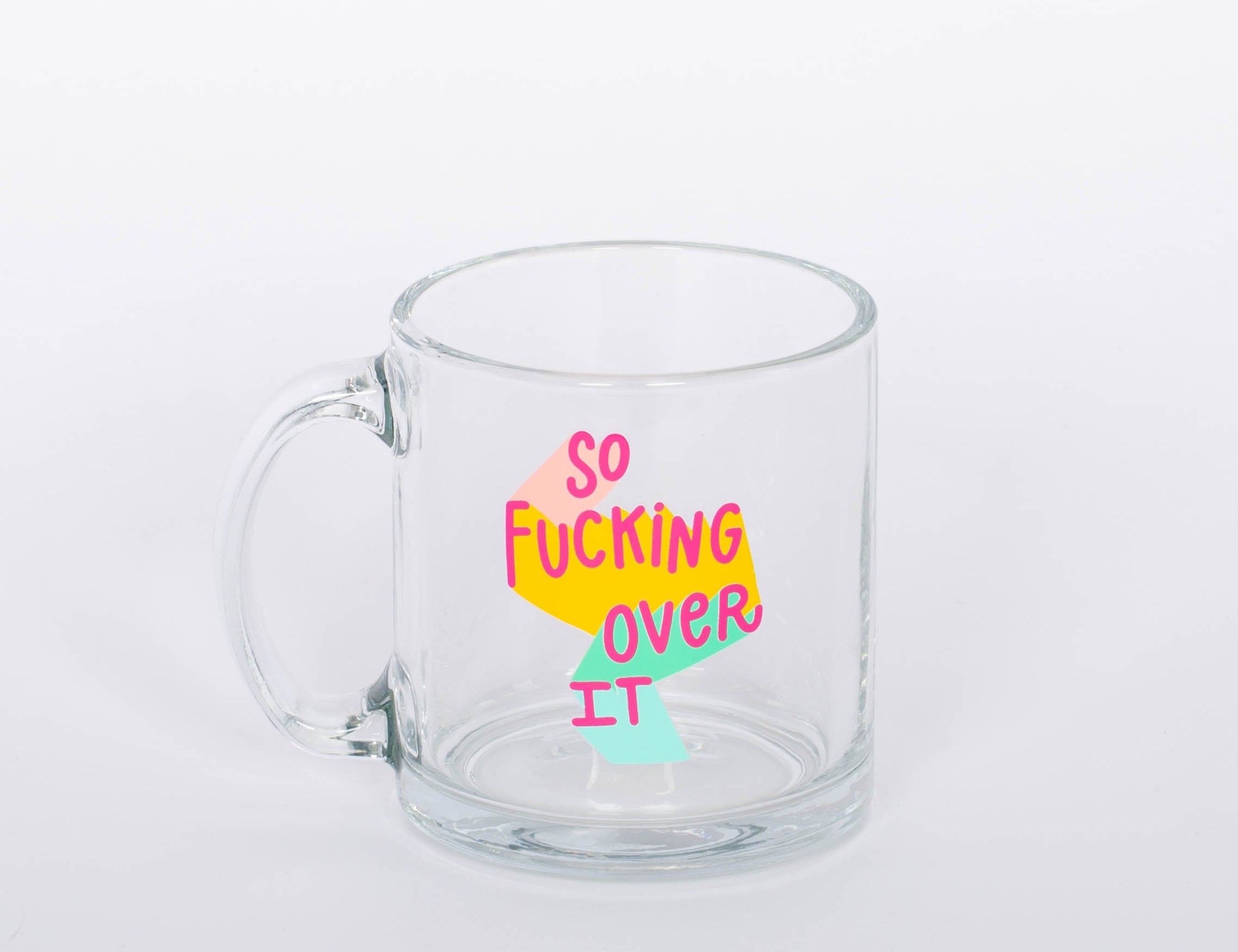 "So Fucking Over It" glass mug. Coffee, tea, hot chocolate, whatever beverage you love, our mug will keep them nice and warm for you. Plus, you'll look super cute drinking out of it.