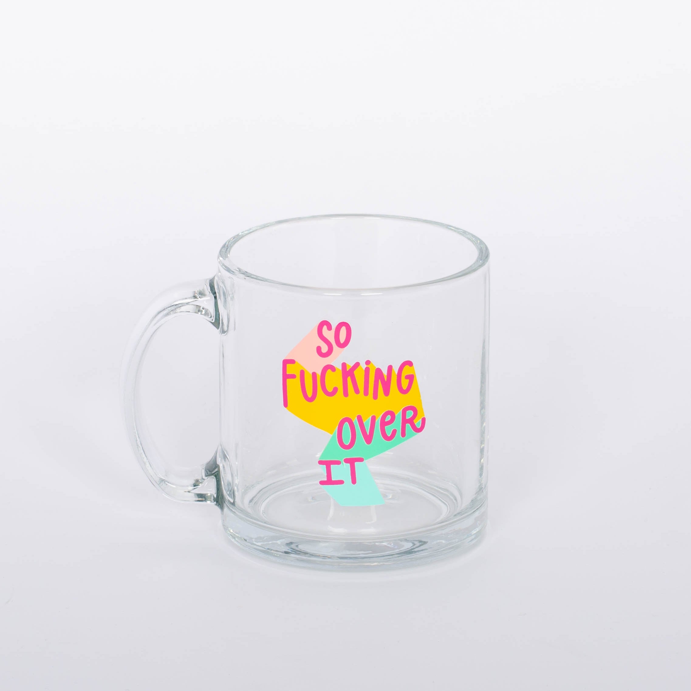 "So Fucking Over It" glass mug. Coffee, tea, hot chocolate, whatever beverage you love, our mug will keep them nice and warm for you. Plus, you'll look super cute drinking out of it.