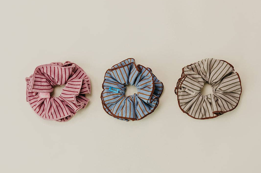 Three scrunchies on a beige background