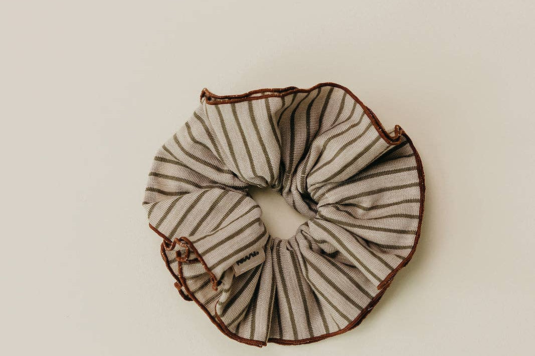 Black and white striped scrunchie on a beige background