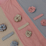 Textured fabric with decorative buttons and ribbons on a multicolored background
