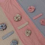 Textured fabric with decorative buttons and ribbons on a multicolored background