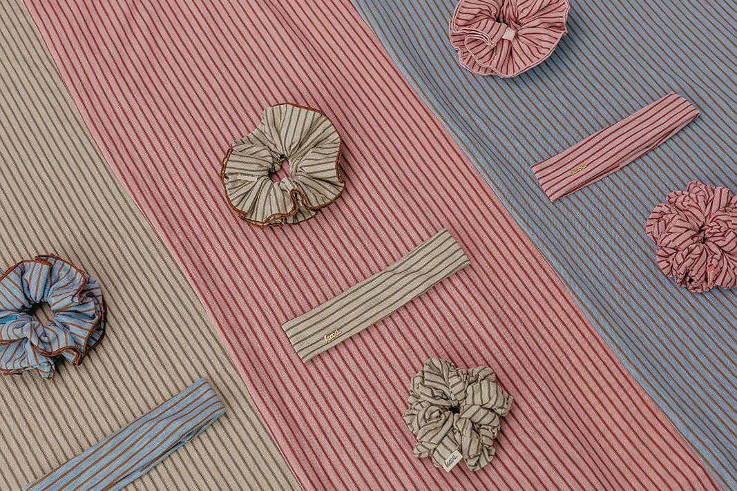 Textured fabric with decorative buttons and ribbons on a multicolored background