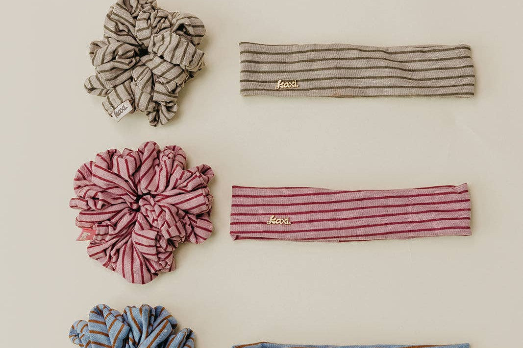 Set of striped headbands and scrunchies on a beige background