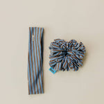 Striped headband and scrunchie set on a beige background