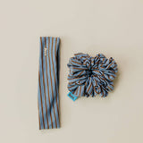 Striped headband and scrunchie set on a beige background