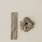 Striped headband and scrunchie set on a beige background