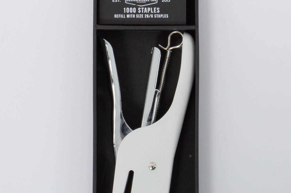 White and silver Standard Issue Stapler by Designworks in black packaging bog with 1000 staples. 