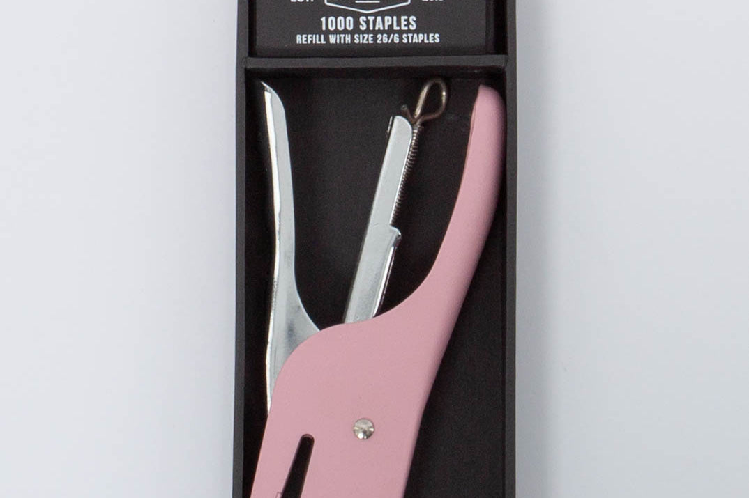 Pink and silver Standard Issue Stapler by Designworks in black packaging bog with 1000 staples. 