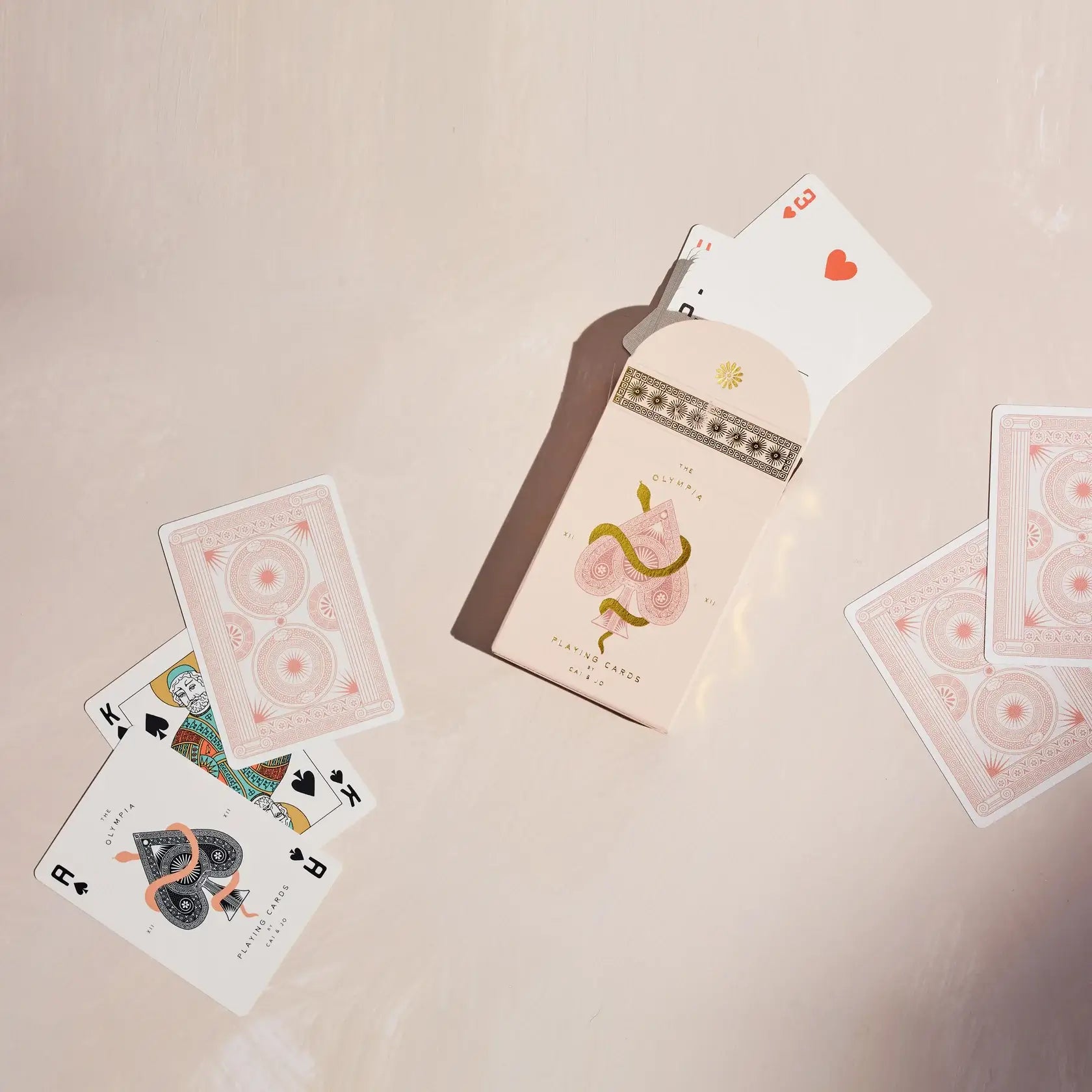 Olympia Playing cards deck in stone with heart and snake illustration