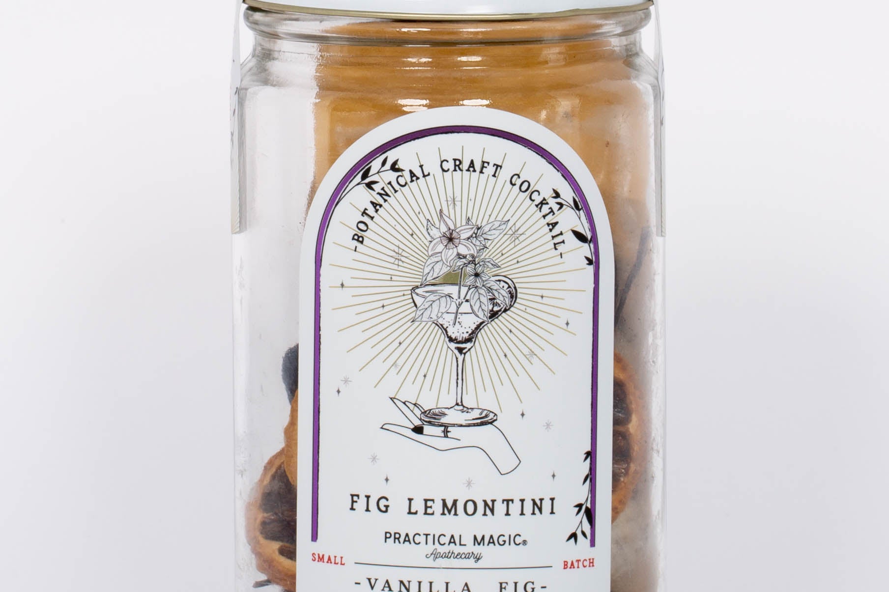 Fig Lemontini Botanical Craft Cocktails Kit by Practical Magic in clear jar with white lid and illustration of hand and drink on label. 