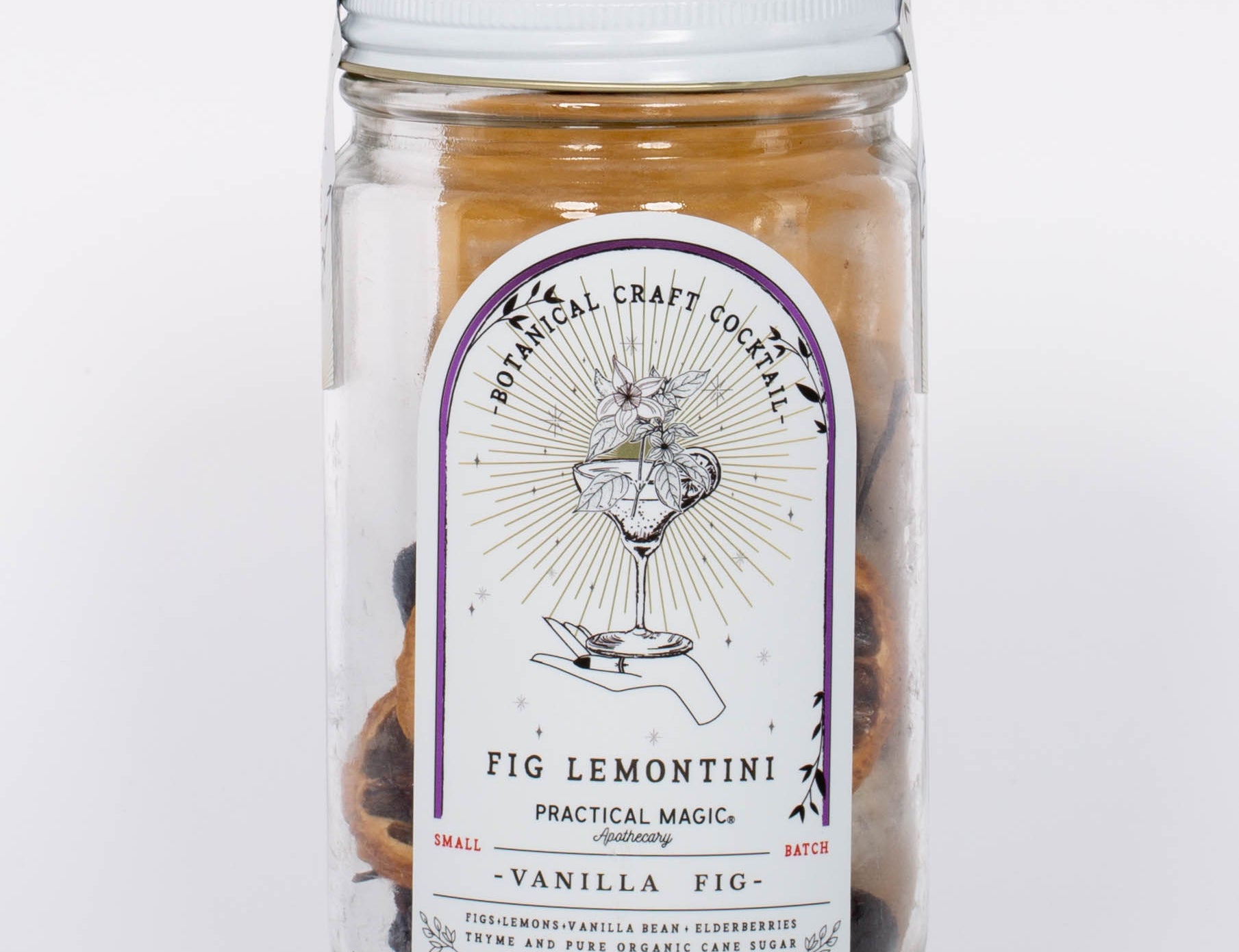Fig Lemontini Botanical Craft Cocktails Kit by Practical Magic in clear jar with white lid and illustration of hand and drink on label. 