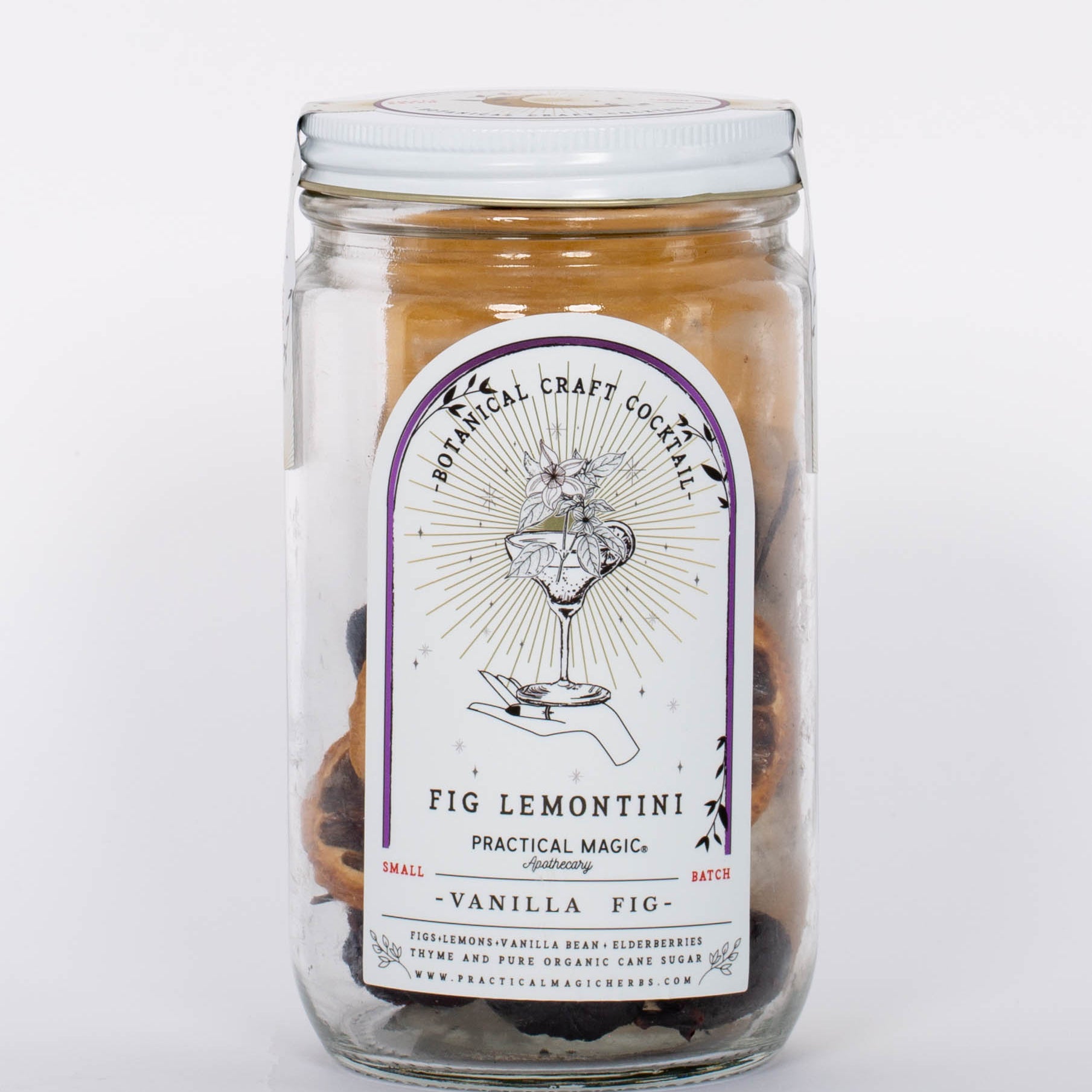 Fig Lemontini Botanical Craft Cocktails Kit by Practical Magic in clear jar with white lid and illustration of hand and drink on label. 