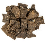 Dark brown dried cubes on a white background