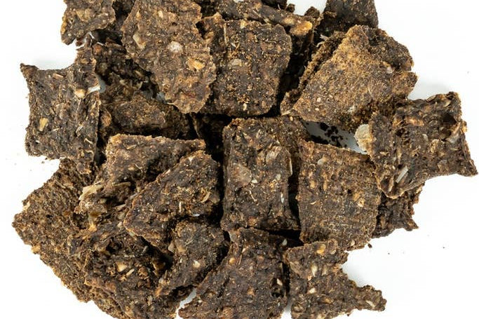 Dark brown dried cubes on a white background