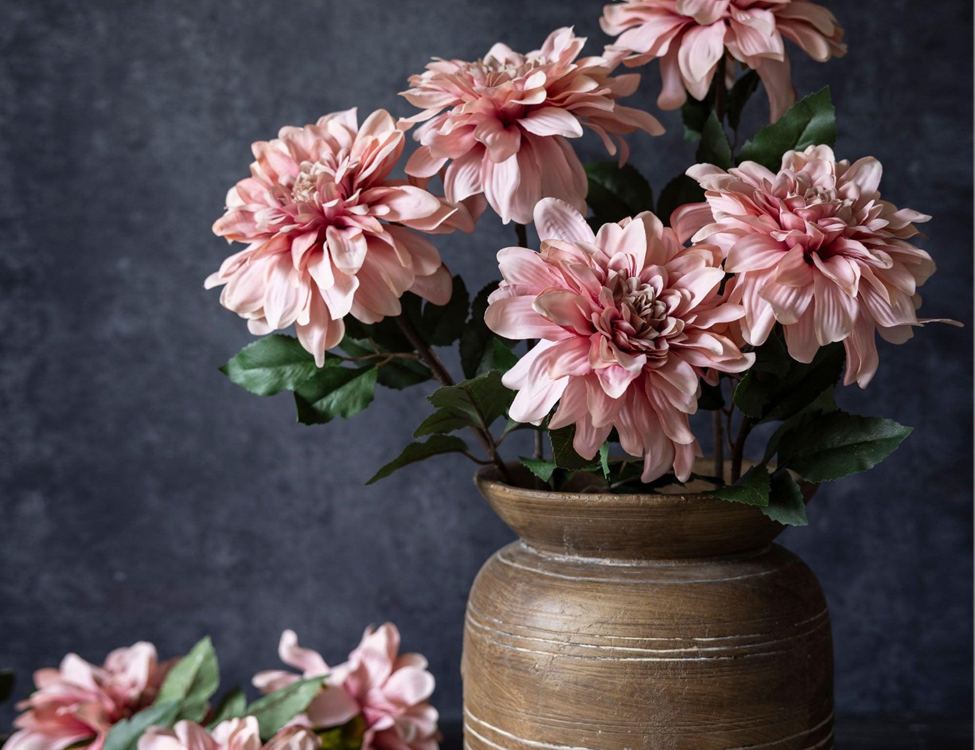 Abigail Ahern Artificial Dahlia Flamingo, dusty pink faux dahlias arranged in a wooden vase on a dark background