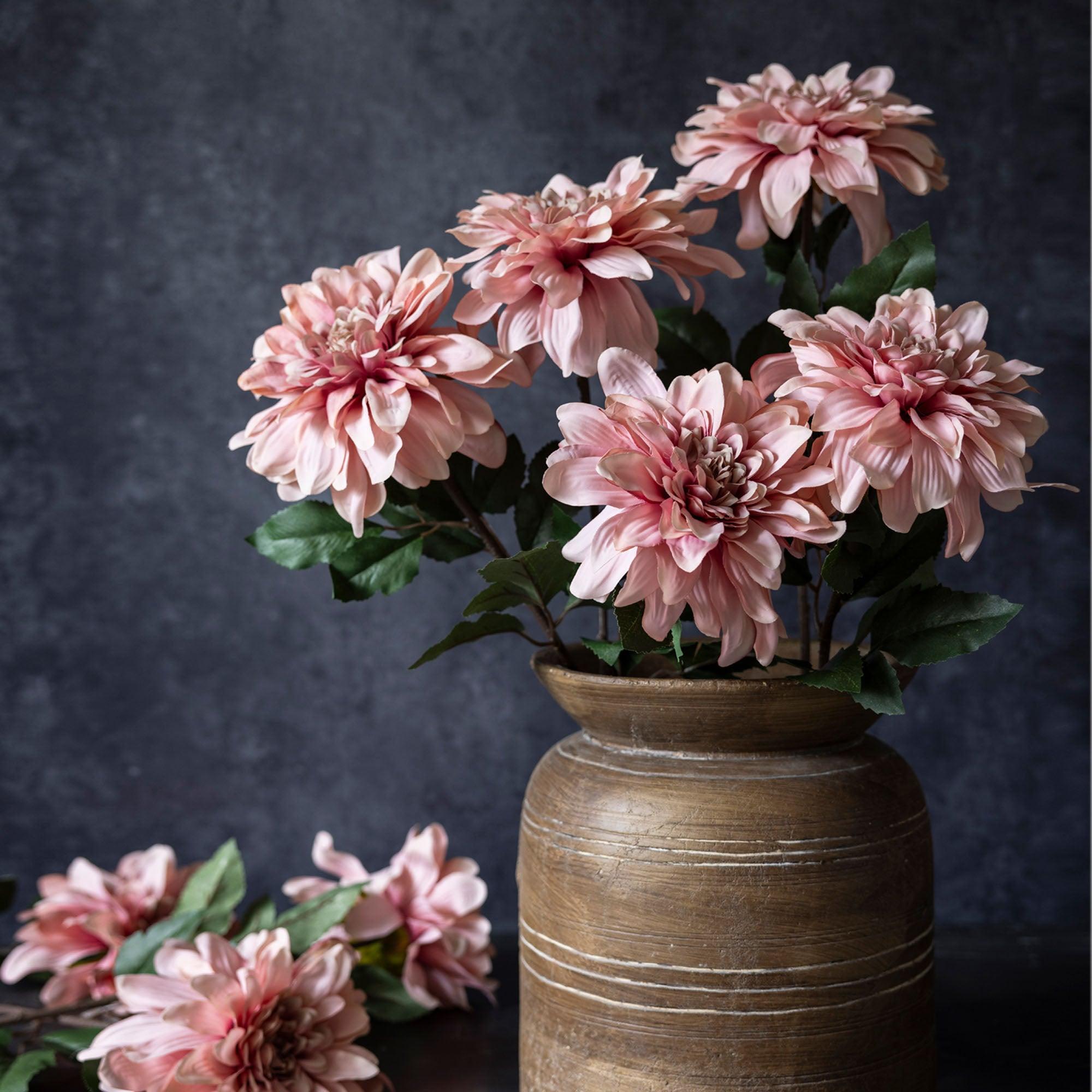Abigail Ahern Artificial Dahlia Flamingo, dusty pink faux dahlias arranged in a wooden vase on a dark background