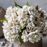 Abigail Ahern Artificial Hydrangea in Morning Mist, close-up of the cream and taupe petals in a brown vase