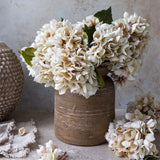 Abigail Ahern Artificial Hydrangea in Morning Mist, cream faux hydrangea heads in a rustic brown vase
