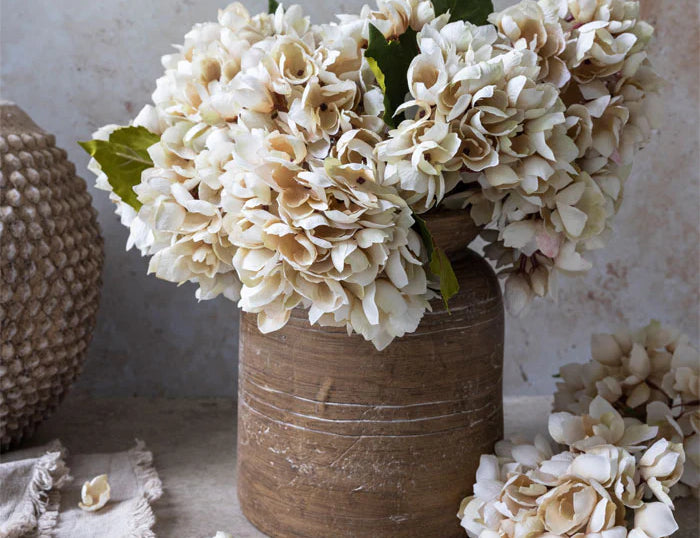 Abigail Ahern Artificial Hydrangea in Morning Mist, cream faux hydrangea heads in a rustic brown vase