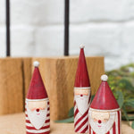 Candystripe Santa Collection, second view of the wooden Santas in red and white hats