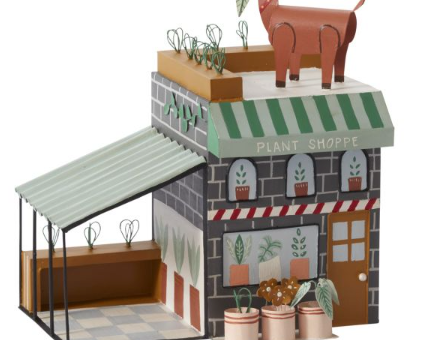 Santa's Plant Shop, decorative plant shop front with green awnings, glass windows, potted plants, and a reindeer on the roof